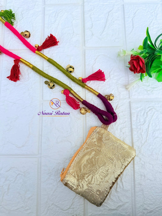 Pink and olive green thread-wrapped mobile sling bag with tassels by Naari Ratan Closed View