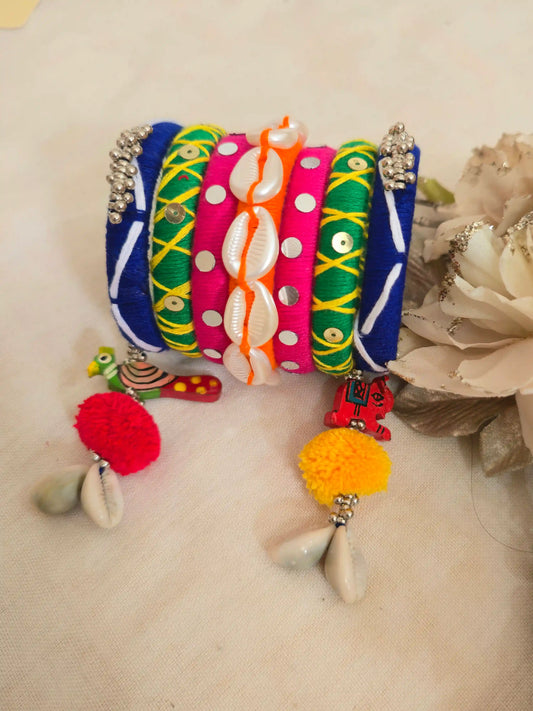 Aadhya Bangles pink thread bangles with mirror work and silver ghunghru and pom pom side view