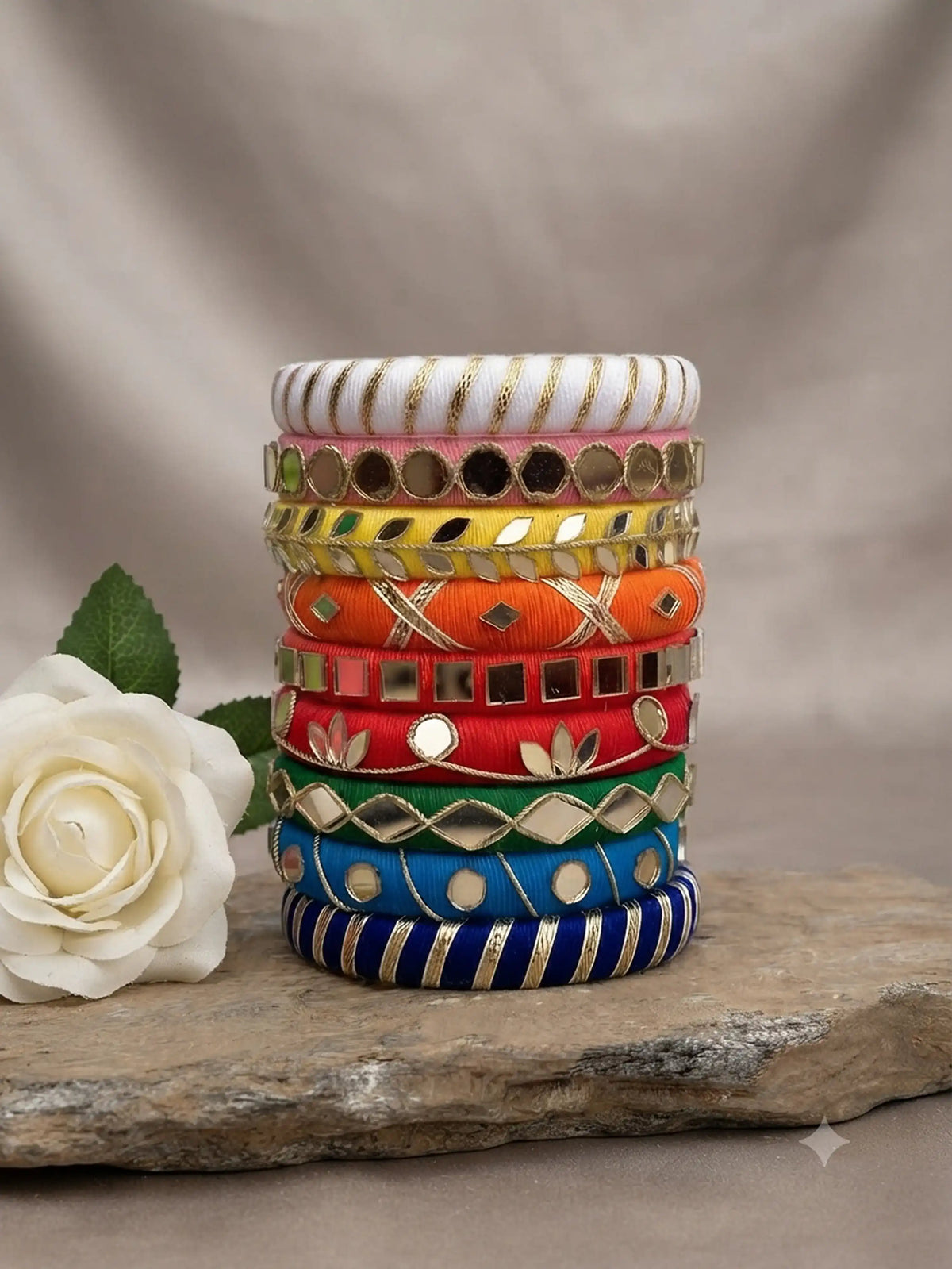 Aadhya Bangles — Multicolor thread bangles with mirror work, silver bells, kundan stones, silver charm ghungroo, parrot motifs, cowrie shells, and pom-poms.