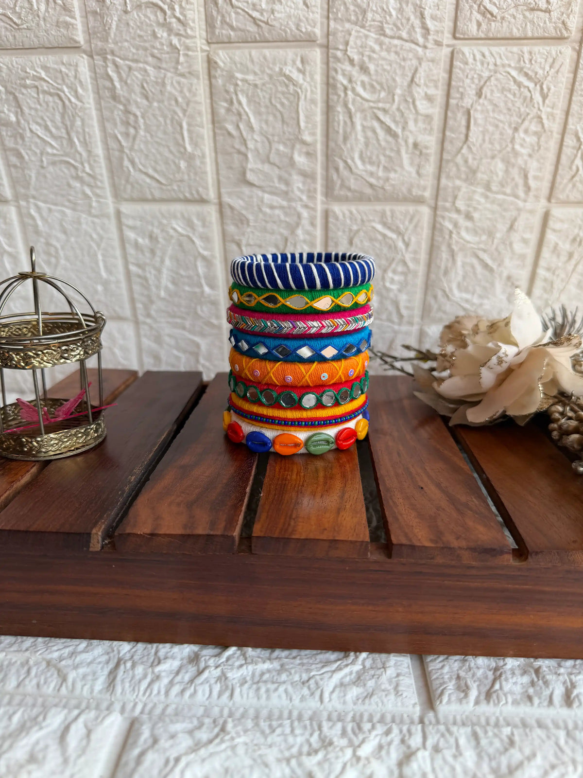 Aadhya Bangles — Multicolor thread bangles with mirror work, silver bells, kundan stones, silver charm ghungroo, parrot motifs, cowrie shells 