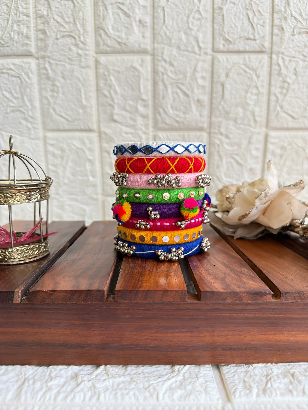 Aadhya Bangles — Multicolor thread bangles with mirror work, silver bells, kundan stones, silver charm ghungroo, parrot motifs, cowrie shells side view