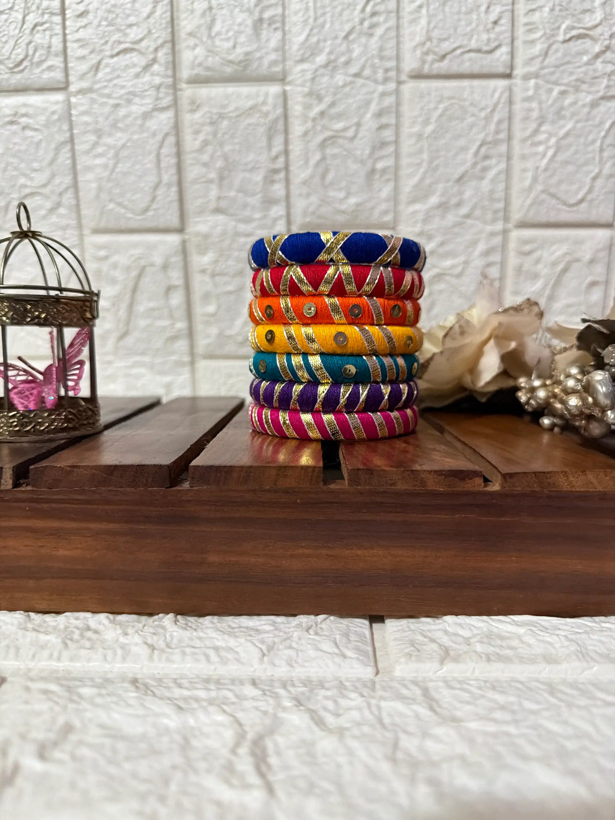 Aadhya Bangles — Multicolor thread bangles with mirror work, silver bells, kundan stones, silver charm ghungroo, parrot motifs, cowrie shells side view