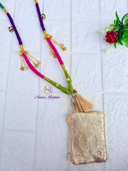 Purple and pink thread-wrapped mobile sling bag with golden charm tassels by Naari Ratan