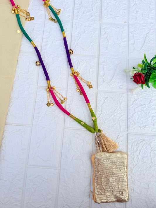 Purple and pink thread-wrapped mobile sling bag with golden charm tassels by Naari Ratan Full View