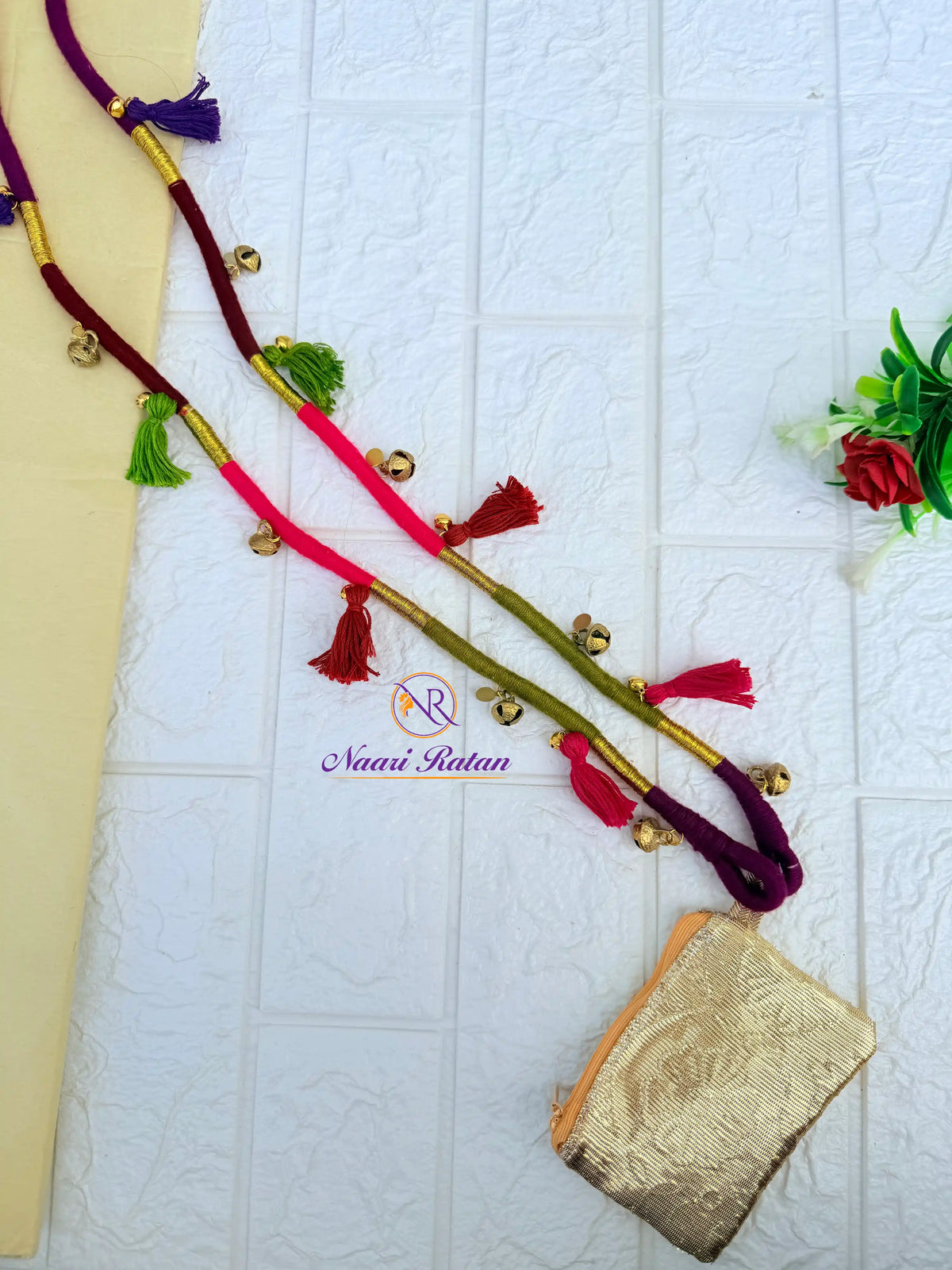 Pink and olive green thread-wrapped mobile sling bag with tassels by Naari Ratan