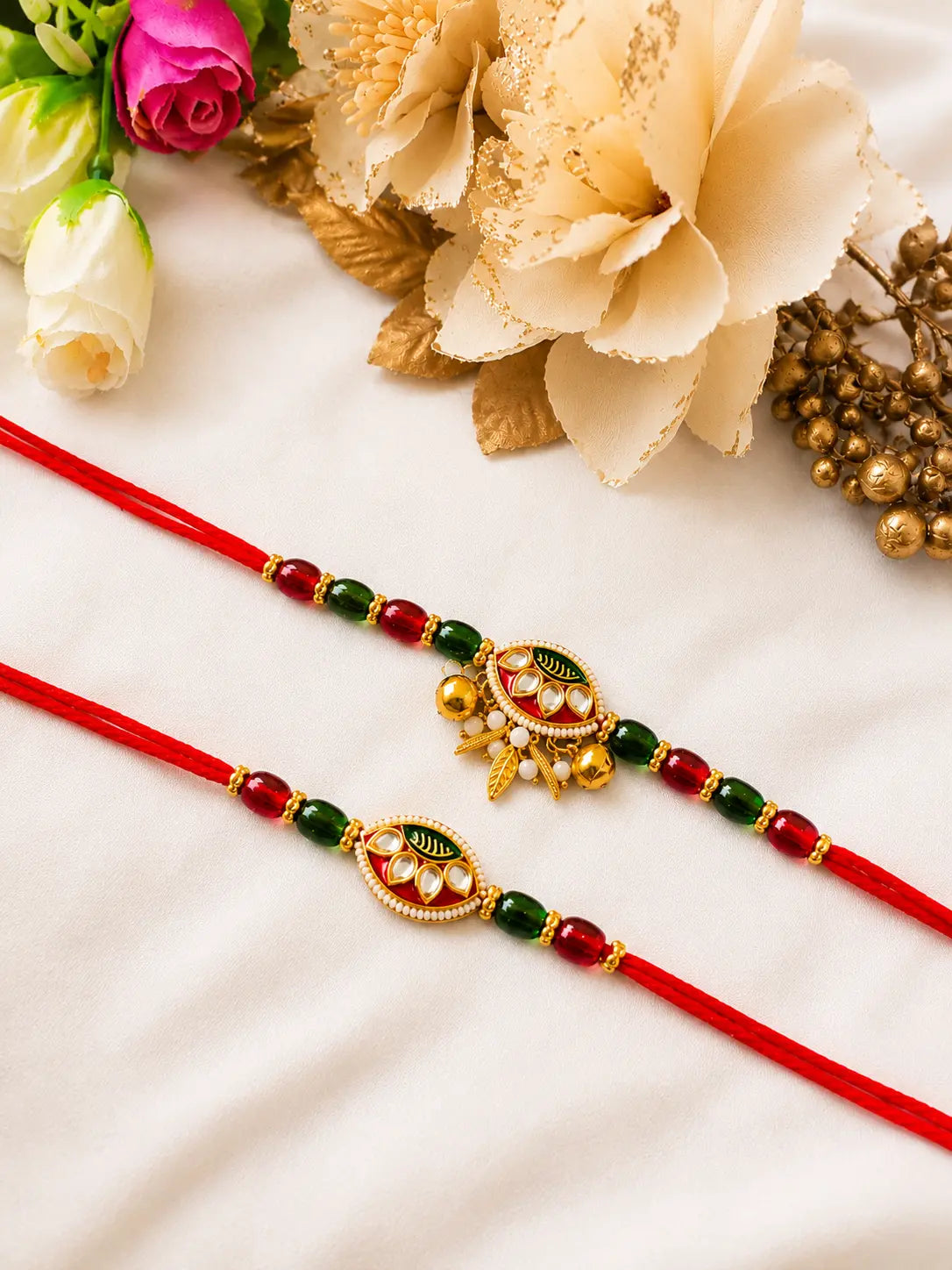Premium Handmade Bhai Bhabhi Rakhi Pair RBB19 by Naari Ratan featuring red thread, green beads, pearl detailing and elegant festive design.